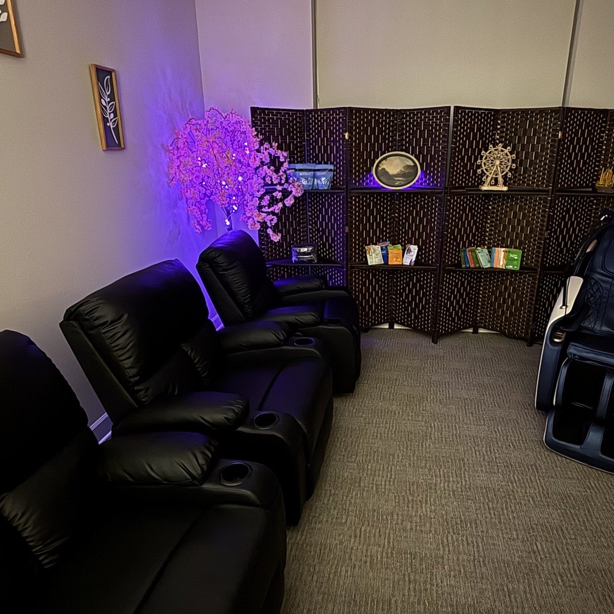 Relaxation Room recliners beside the woven screen and blossom tree